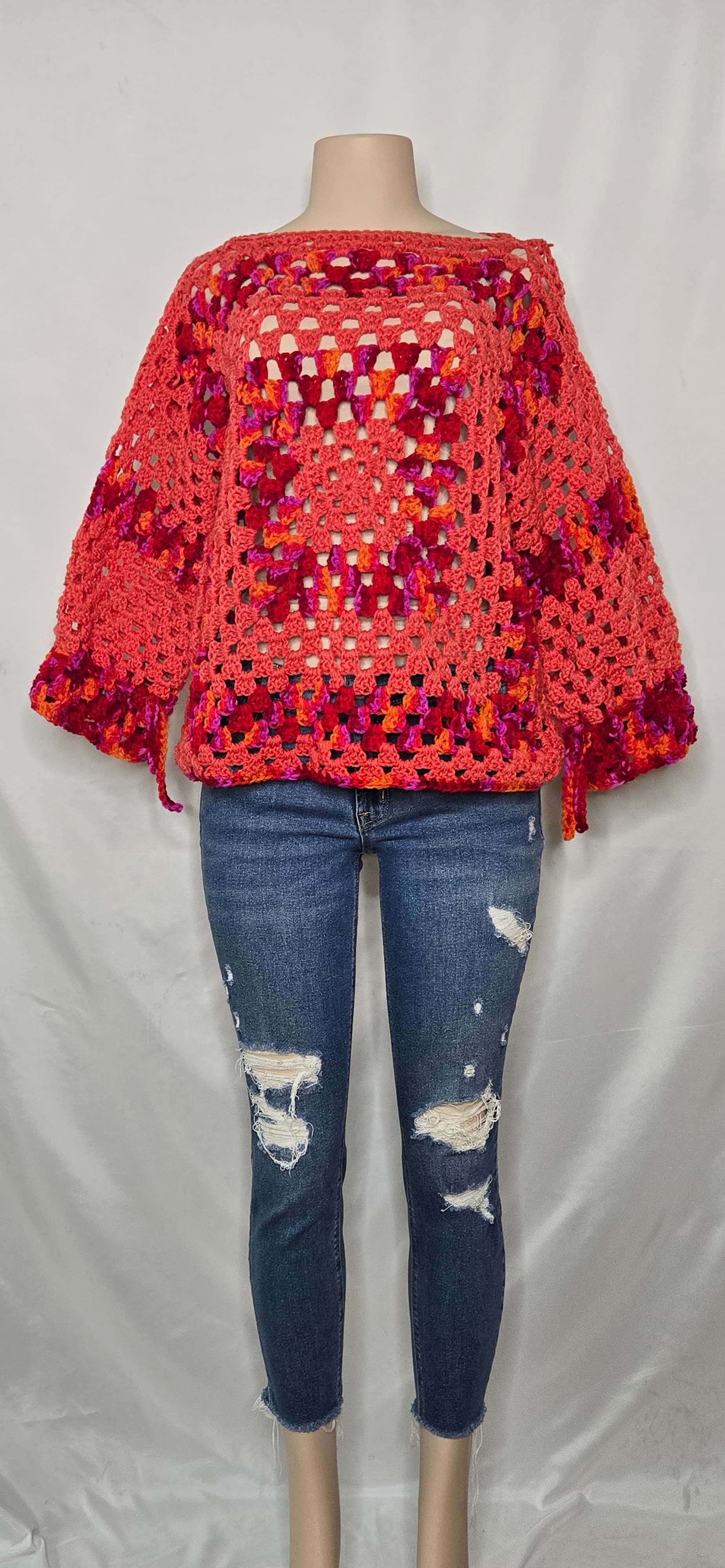 Purple and pink textured crocheted cardigan on a mannequin